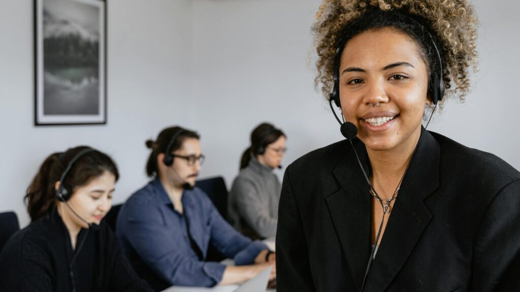 Happy hotline worker smiles.