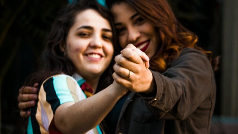Queer women holding hands.