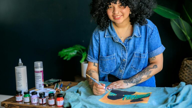Woman paints the back of a jacket.