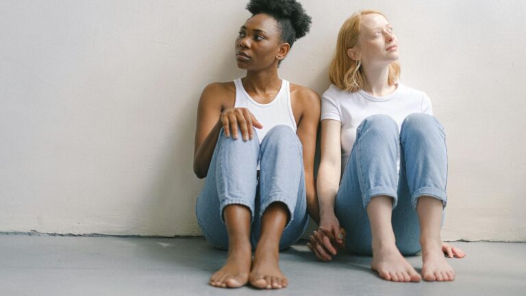 Couple on a hike makes heart hands.