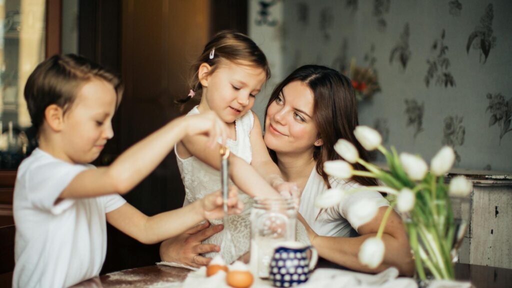 Mother admires children playing.