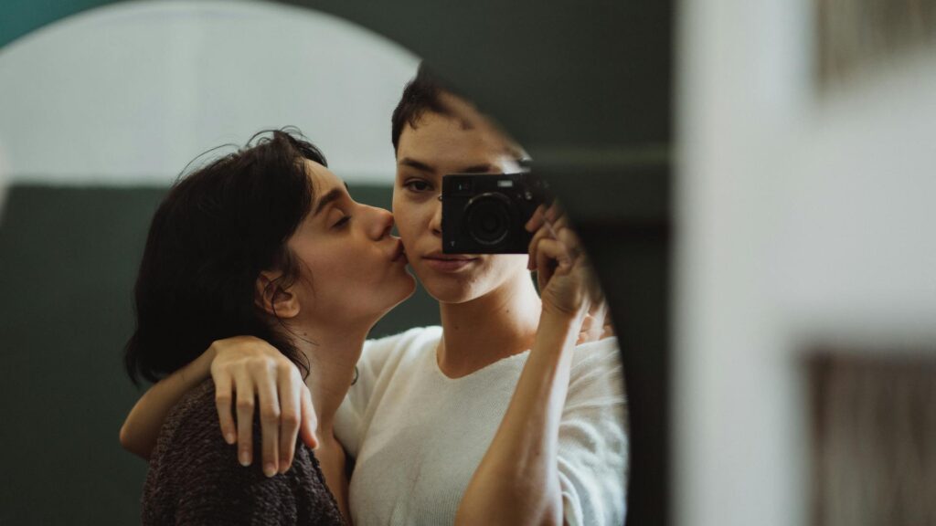 Women take a photo in the mirror.
