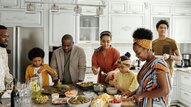 A larger family cooks together in a kitchen