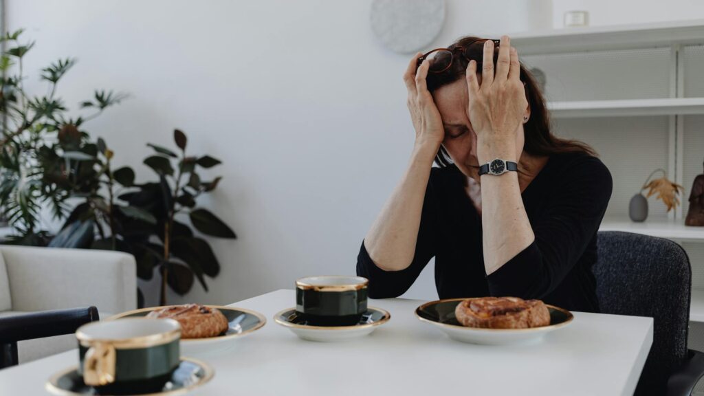 Sad woman at breakfast table