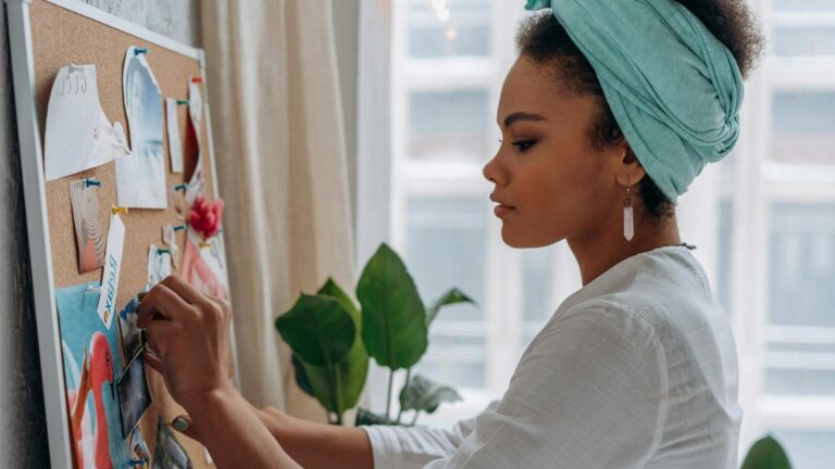 Headshot of Lauren Lazo a woman with long blonde hair wearing a white lace top and black leather jacket
