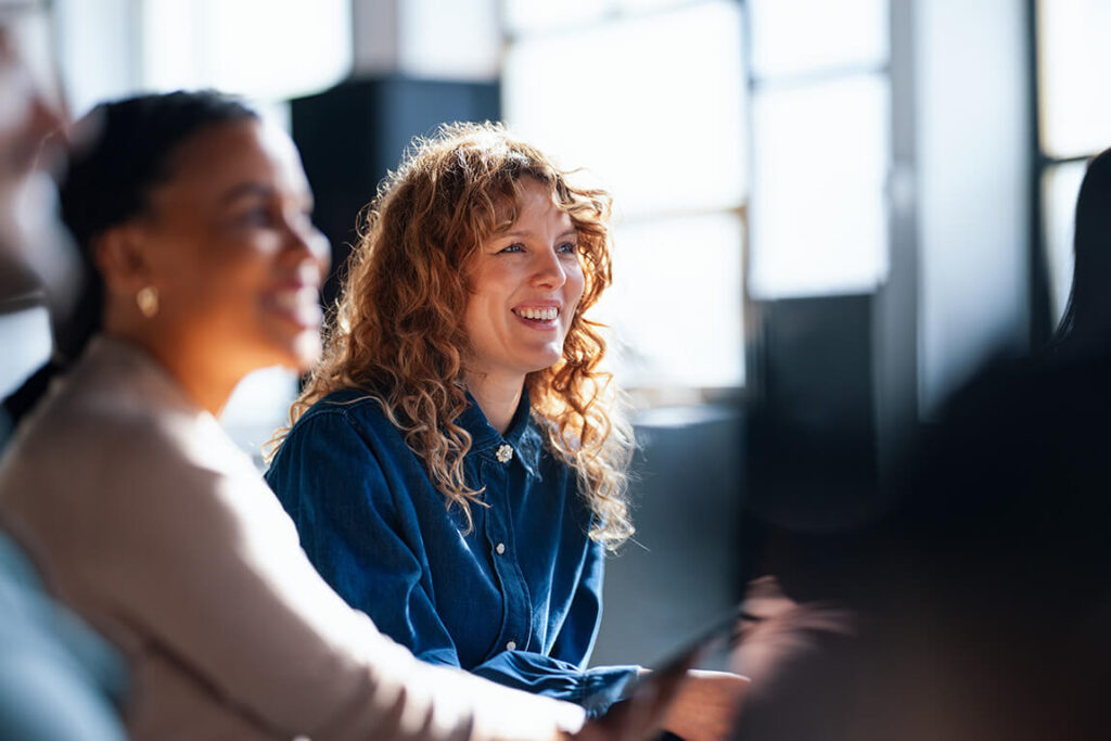 Two working professionals review health insurance coverage options together.